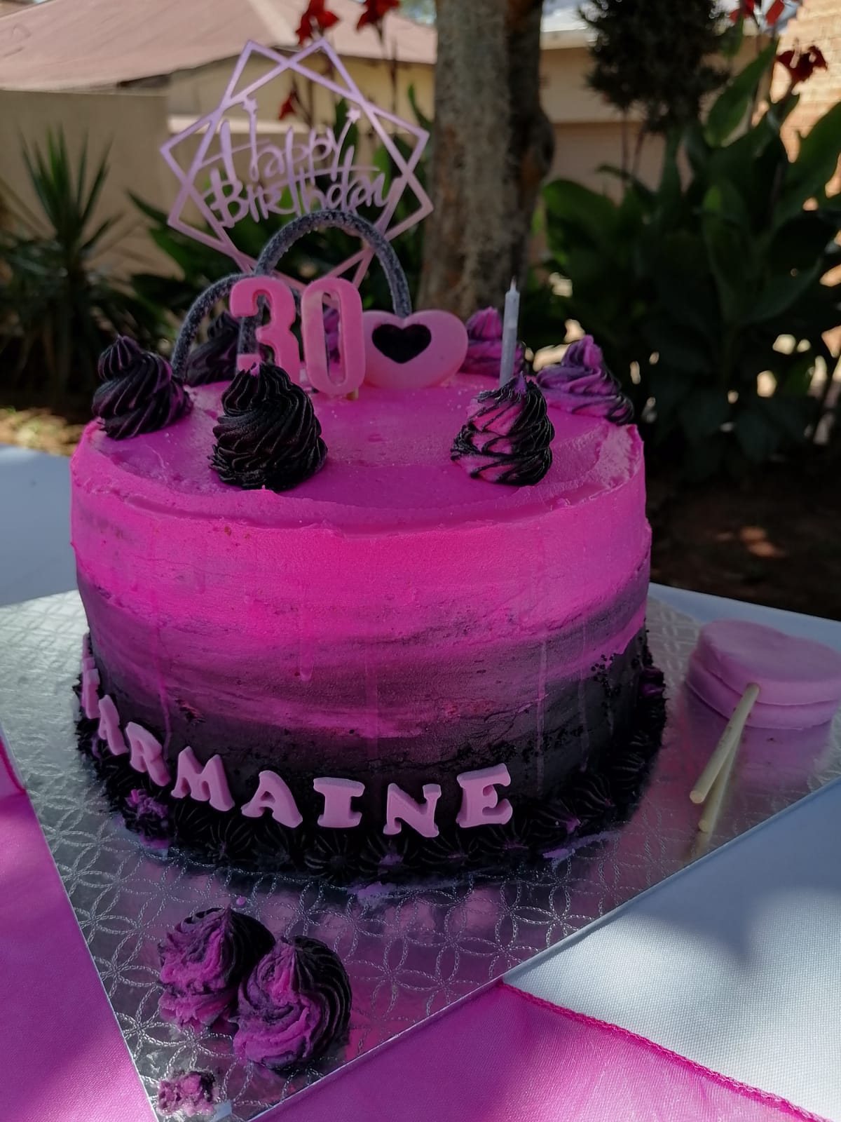 Pink birthday cake with chocolate decorations and 30th birthday topper