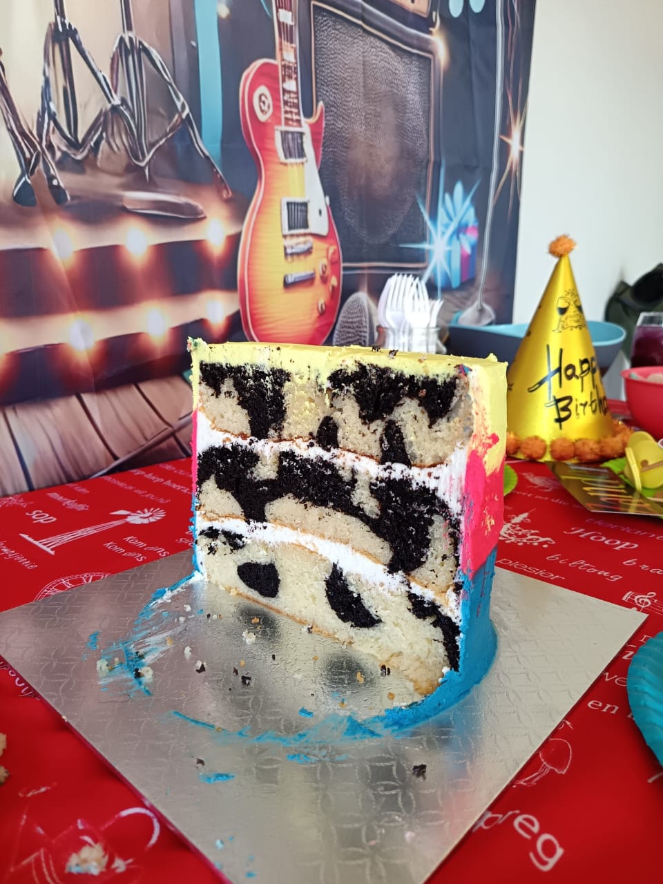 Black and white marble cake slice with birthday decorations
